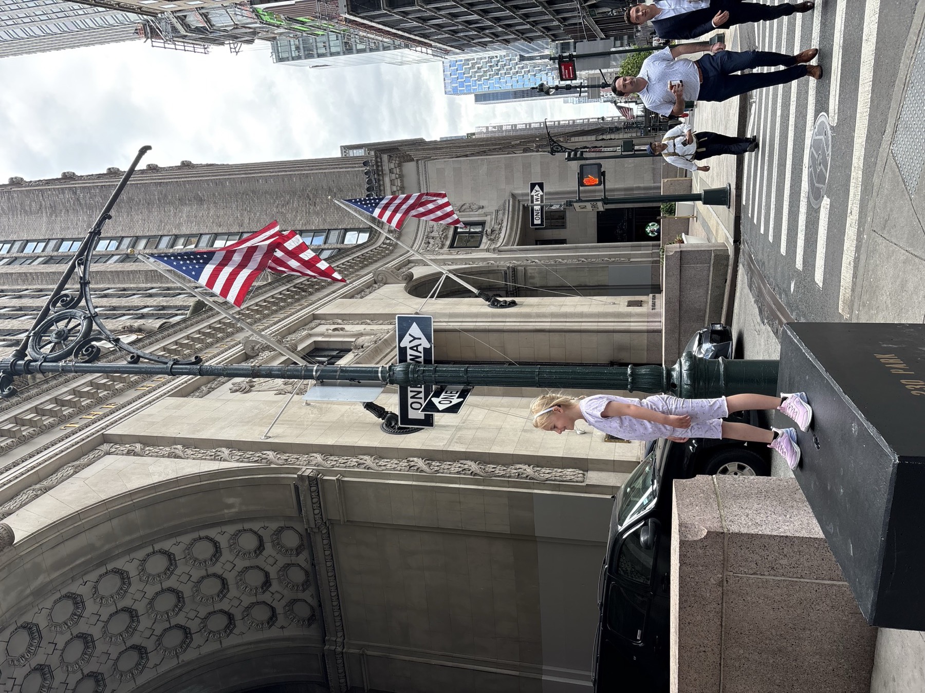The New York Stock Exchange from farther back, with enough open space to let the kids move instead of just being dragged along